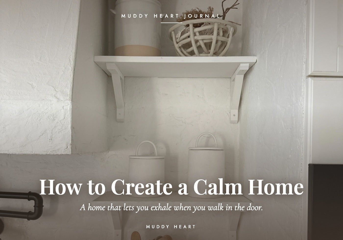 Two lidded handmade ceramic canisters on a white shelf in a white-brick kitchen alcove, titled 'How to Create a Calm Home' — Muddy Heart Journal