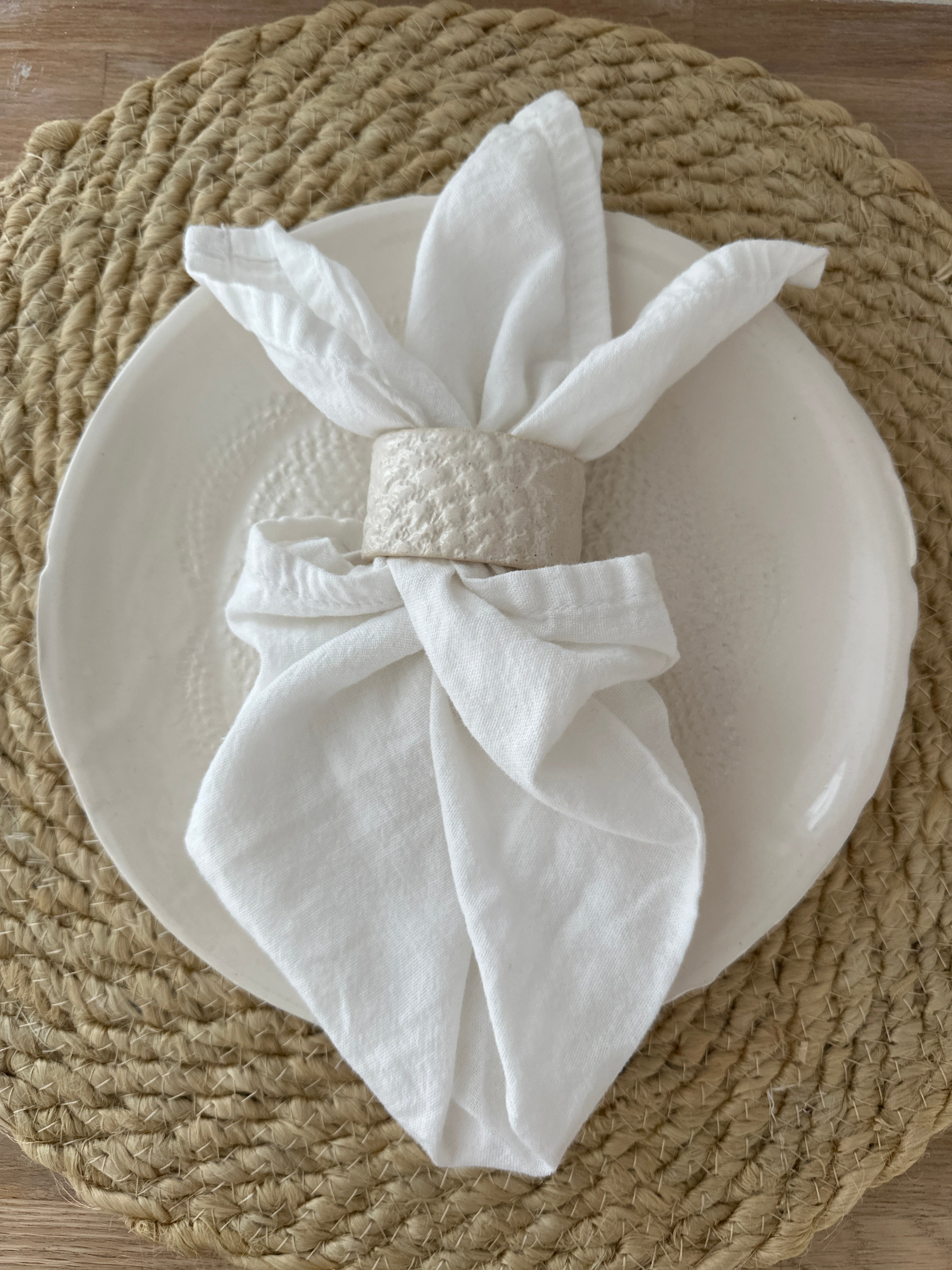 Handmade ceramic place setting with linen napkin, set for a gathered meal