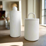 Handmade ceramic staggered storage canisters in various sizes and colors