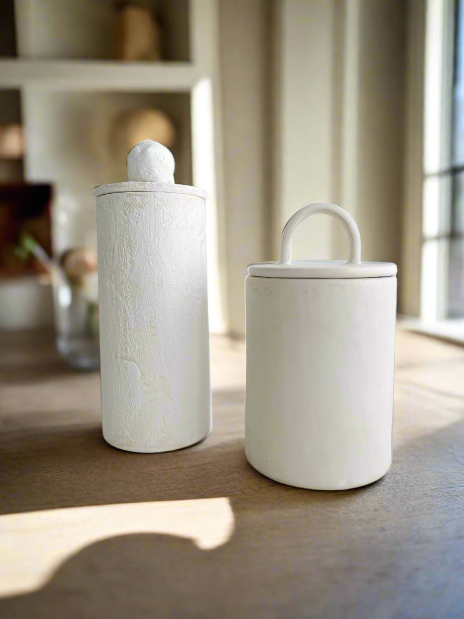 Handmade ceramic staggered storage canisters in various sizes and colors