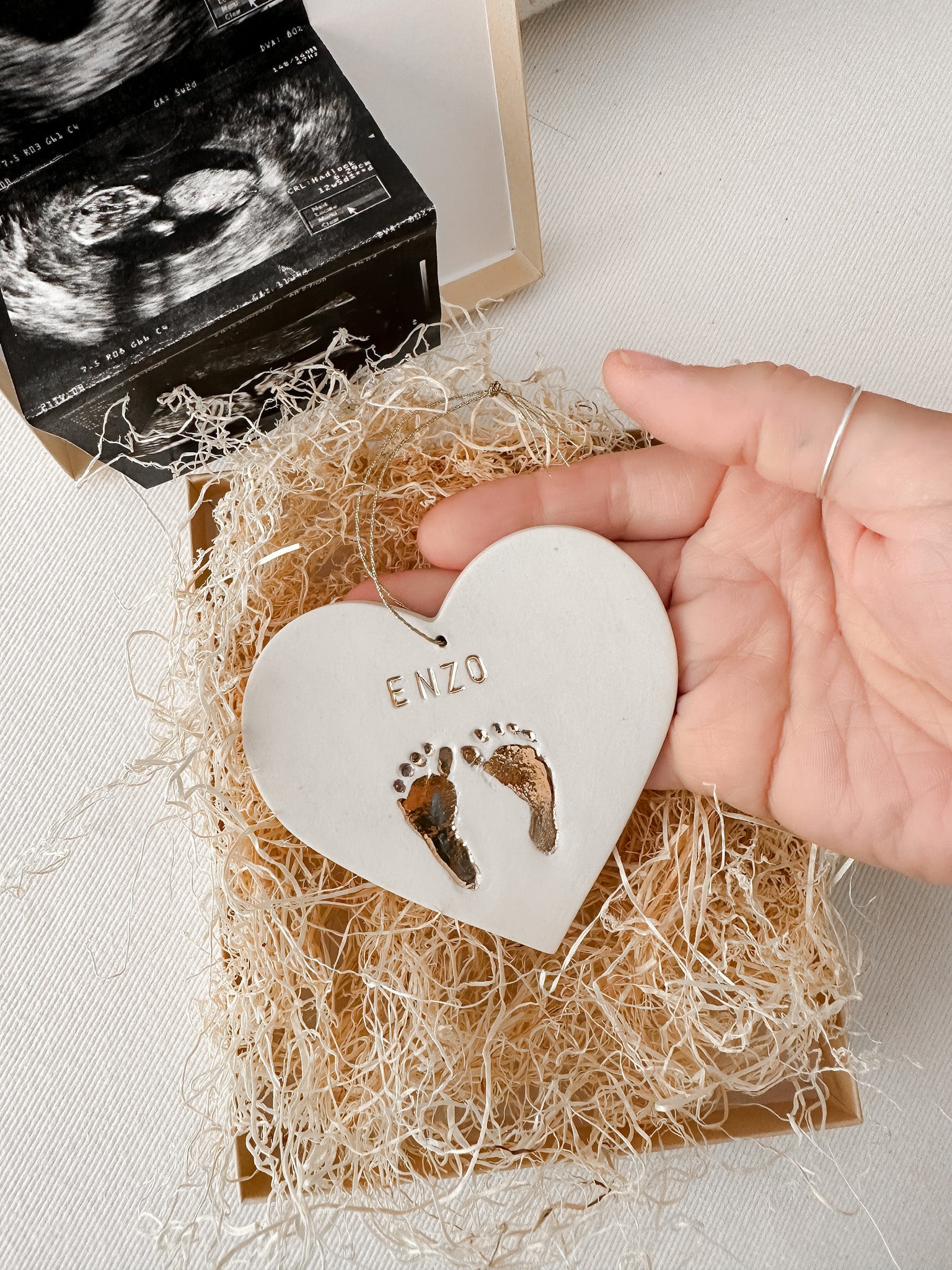 Handmade personalized ceramic baby ornament with gold footprints