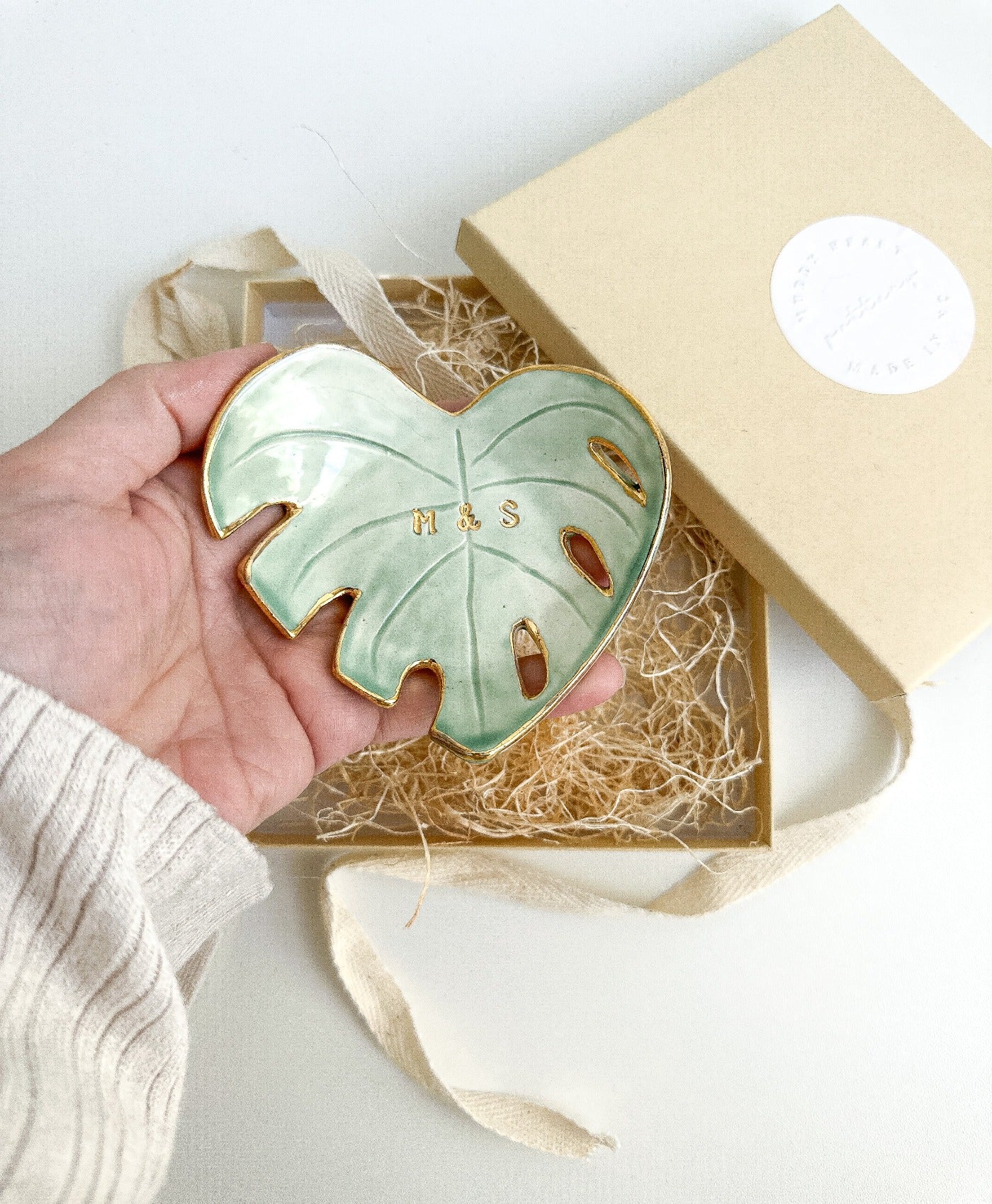 Unique green monstera leaf ceramic dish with personalized gold initials, perfect for boho home decor