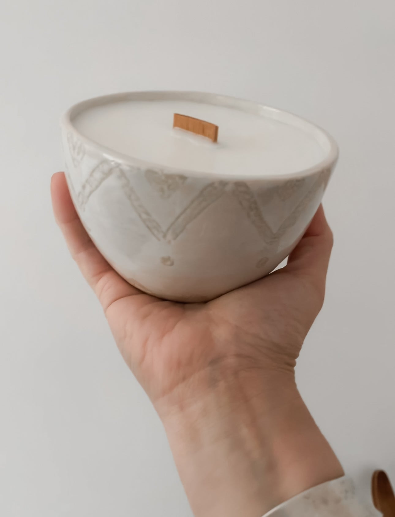 Stylish hand-poured soy candle with vanilla scent and ceramic bowl