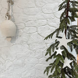 Timeless white ceramic star ornaments, lovingly handmade with unique textures, perfect for chic holiday decor