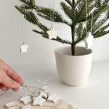 Elegant set of 12 handmade ceramic star ornaments, ideal for adding a magical touch to your holiday decor