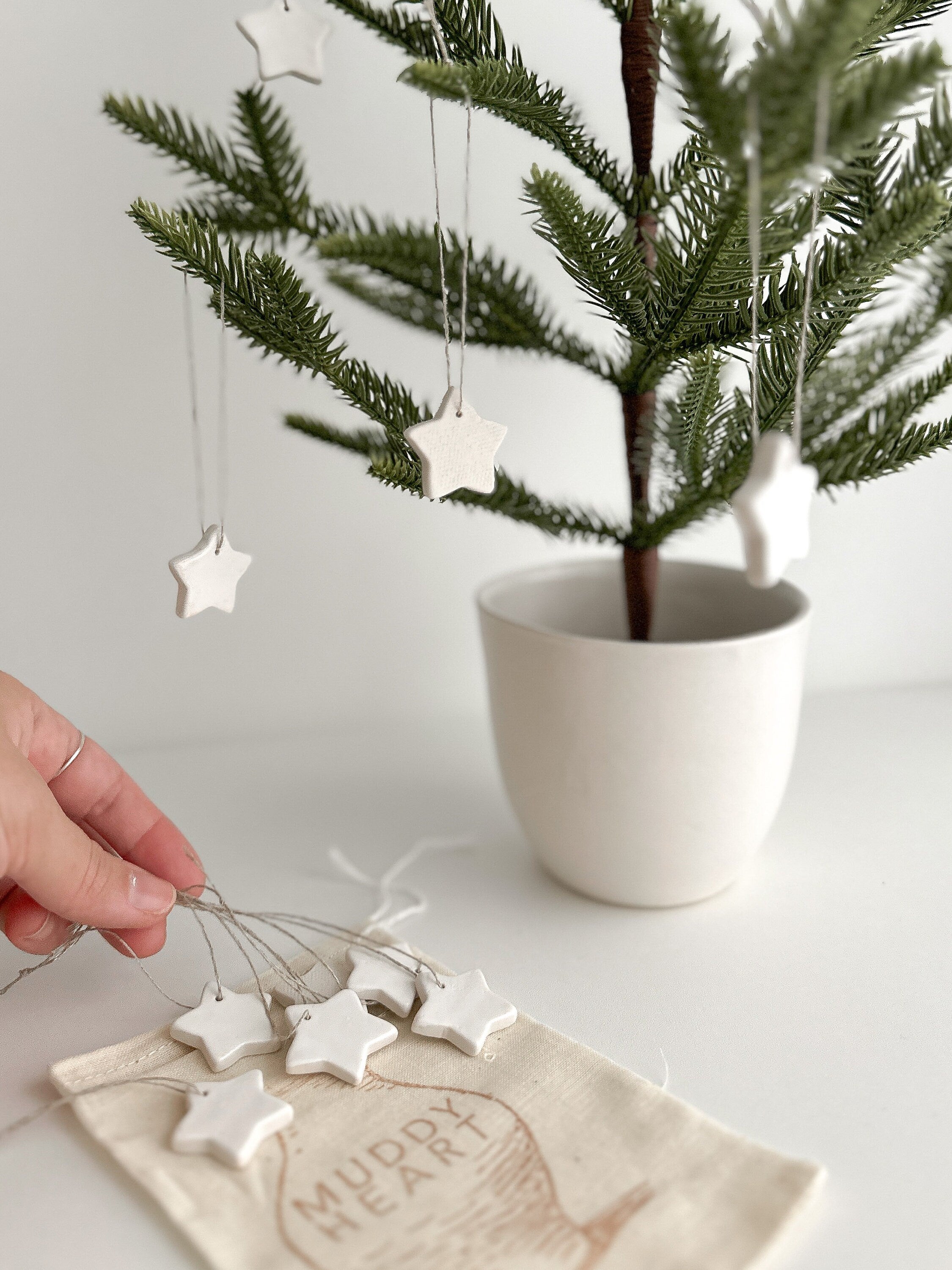 Elegant set of 12 handmade ceramic star ornaments, ideal for adding a magical touch to your holiday decor