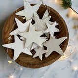 Distinctive white ceramic star ornaments, handcrafted for a sophisticated and elegant holiday look