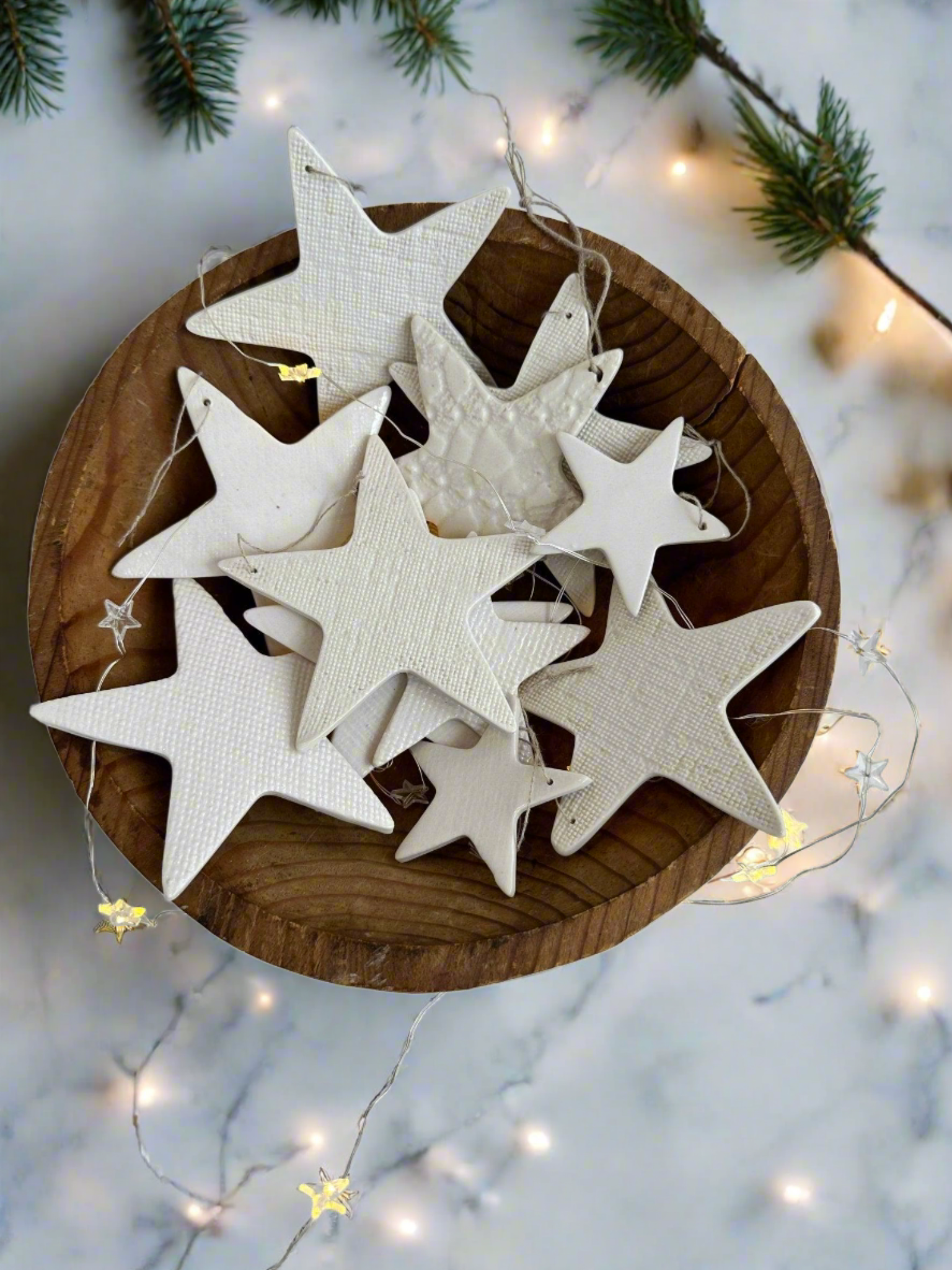 Distinctive white ceramic star ornaments, handcrafted for a sophisticated and elegant holiday look