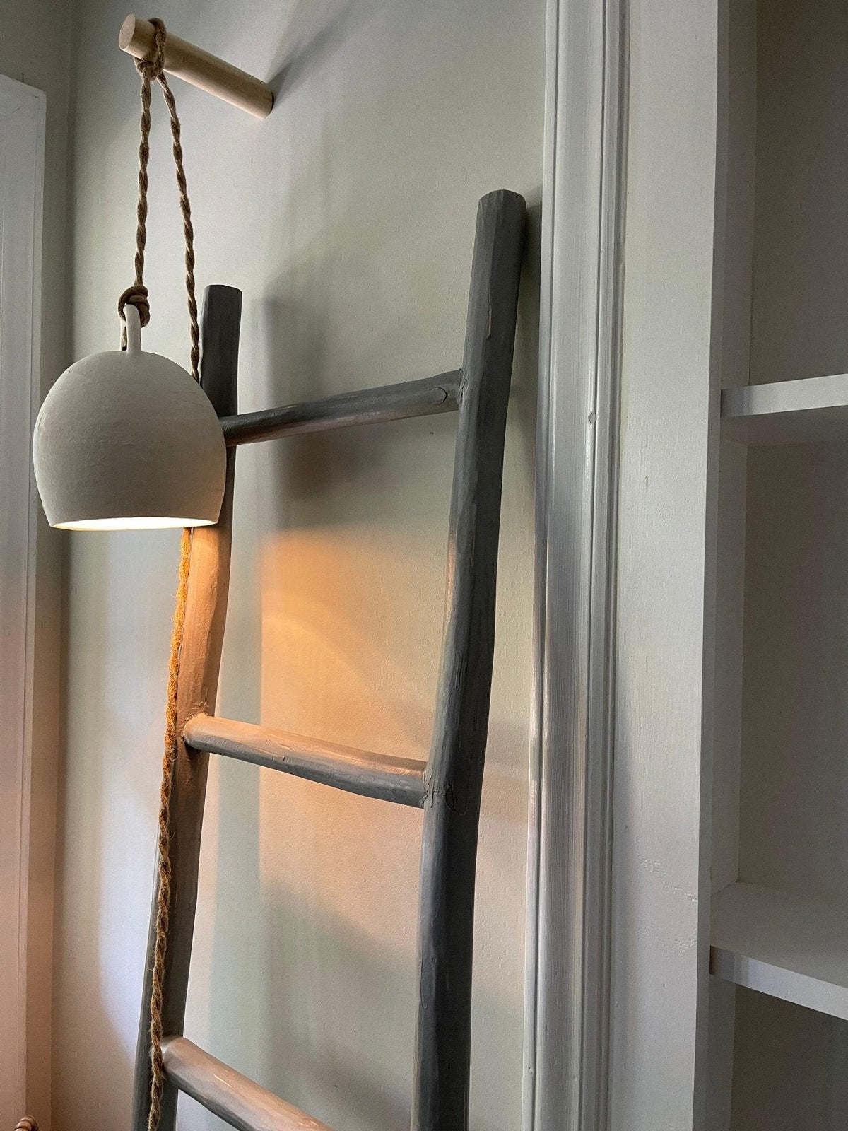 Handmade ceramic bell pendant light in a neutral finish